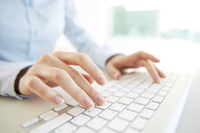 Hands of an office woman typing