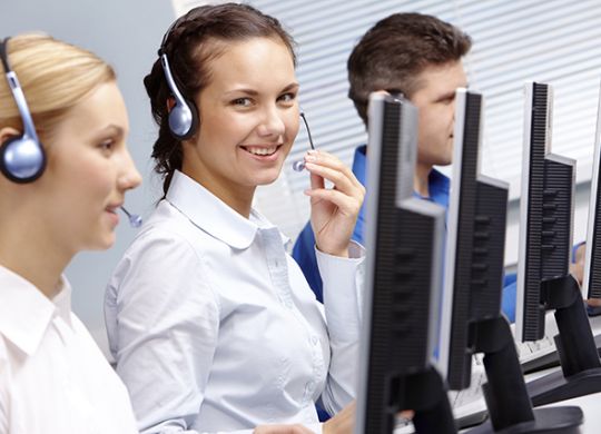 Business team of operators sitting at the table during telephone conversation