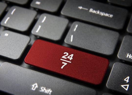 Online business always open concept: red key with 24/7 working hours symbol on laptop keyboard. Included clipping path, so you can easily edit it.