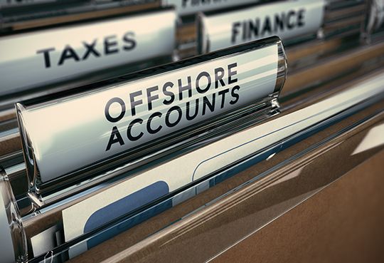 Folder tabs with focus on offshore account tab. Business concept image for illustration of tax evasion.